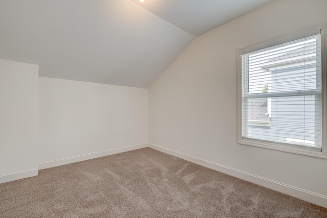 additional living space with lofted ceiling and carpet floors