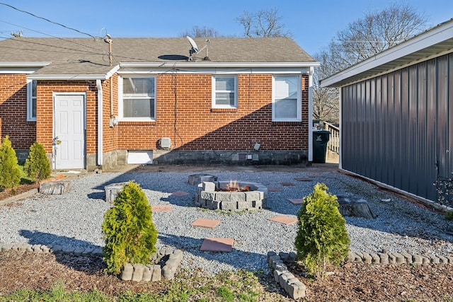 rear view of house featuring a fire pit