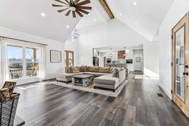 living room featuring beamed ceiling, dark hardwood / wood-style floors, high vaulted ceiling, and a notable chandelier