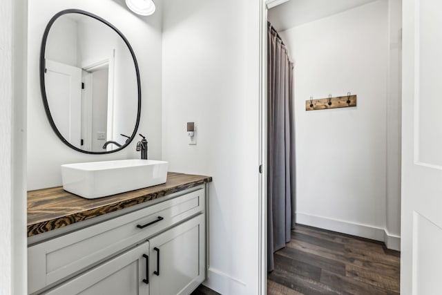 bathroom with hardwood / wood-style floors and vanity