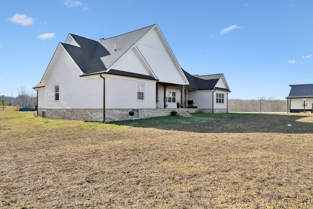 rear view of property with a yard