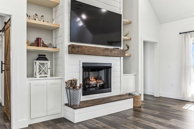 living room with lofted ceiling, built in features, and dark wood-type flooring