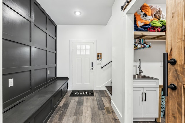 mudroom featuring sink and dark hardwood / wood-style floors