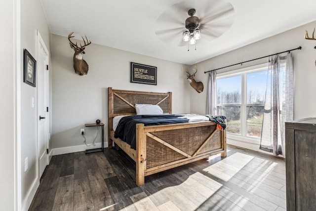 bedroom with ceiling fan and dark hardwood / wood-style floors