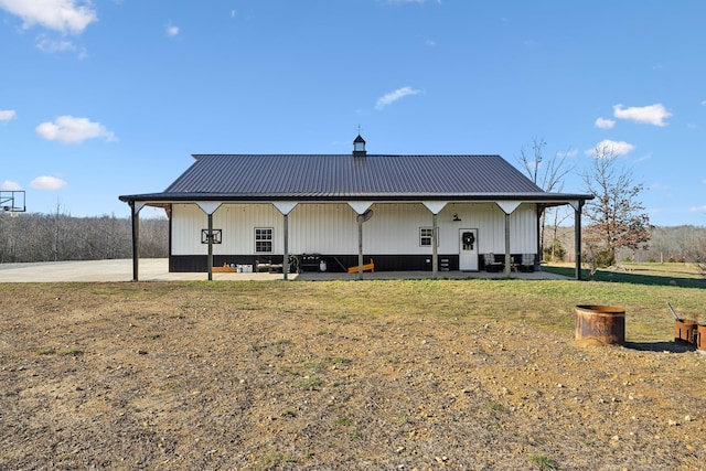 back of house with a lawn and a patio area