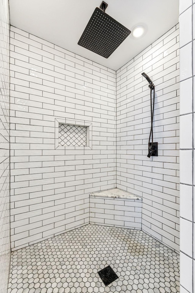 bathroom with tiled shower