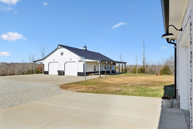 view of side of property with a lawn and a garage