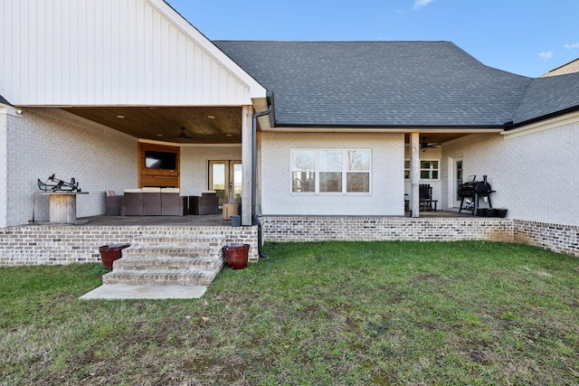 back of property featuring ceiling fan, a yard, and a patio