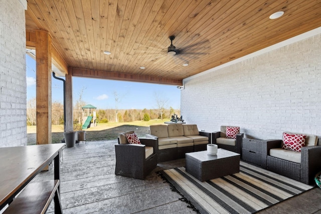 view of patio featuring a playground, an outdoor living space, and ceiling fan