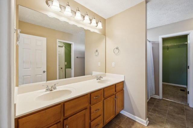 bathroom featuring vanity and a textured ceiling