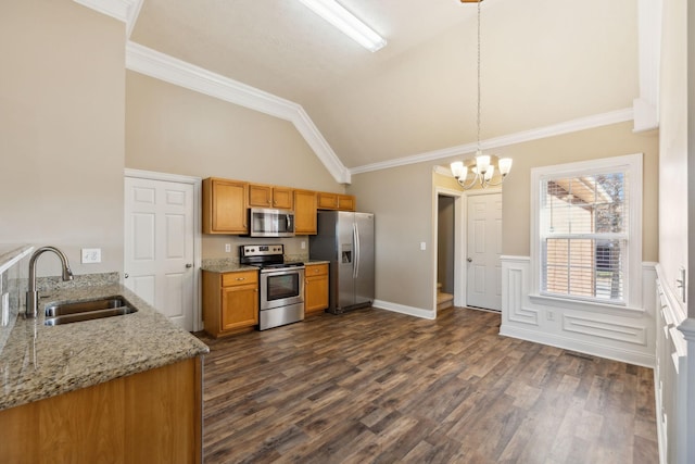 kitchen with light stone countertops, stainless steel appliances, vaulted ceiling, sink, and hanging light fixtures