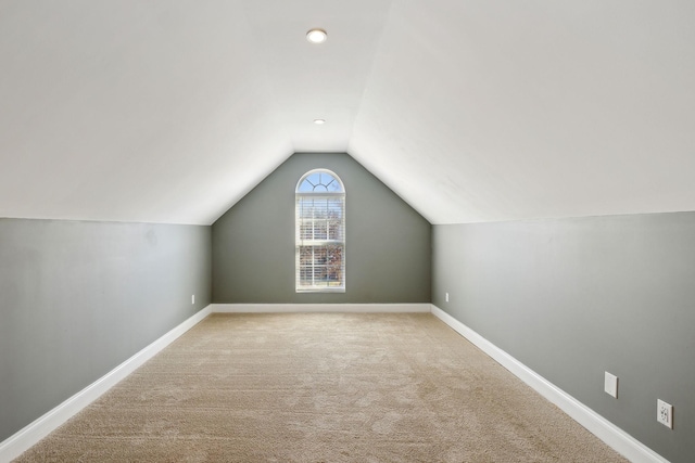 bonus room featuring light carpet and lofted ceiling