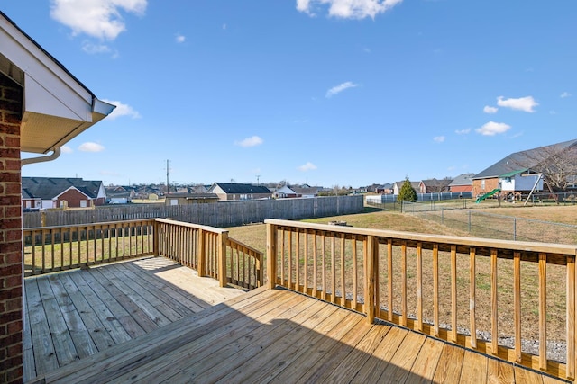 wooden terrace featuring a yard