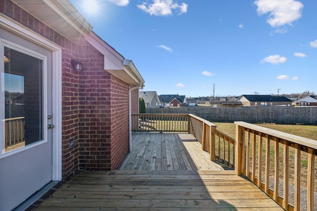 wooden deck with a lawn