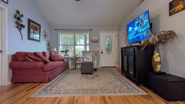 living room featuring hardwood / wood-style floors and vaulted ceiling