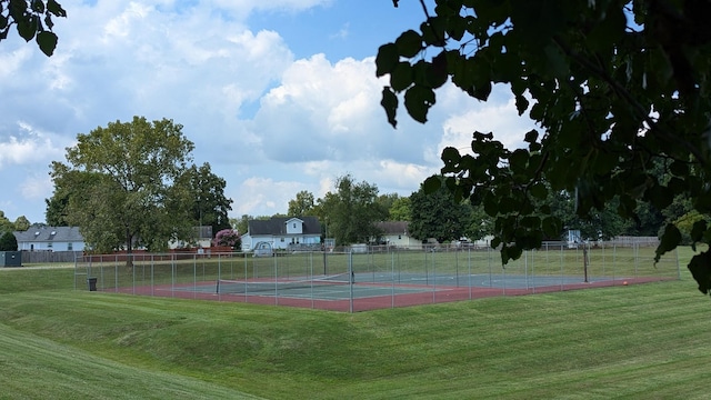 view of sport court featuring a yard