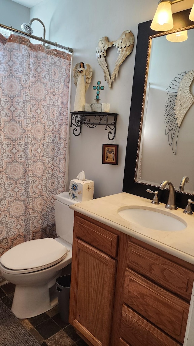 bathroom featuring curtained shower, vanity, and toilet