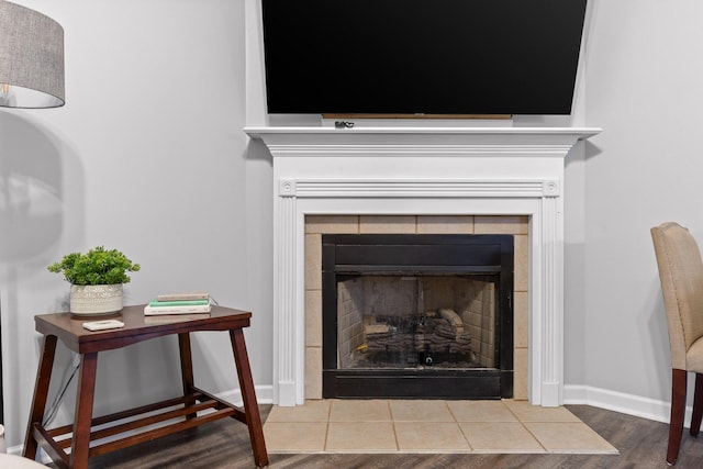 room details with hardwood / wood-style flooring and a tile fireplace