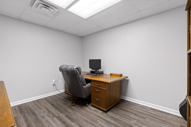 office area featuring dark hardwood / wood-style floors and a drop ceiling