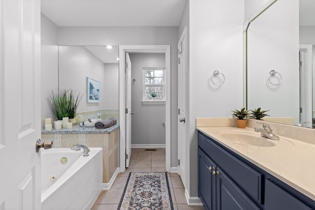 bathroom featuring vanity, a bath, and tile patterned floors