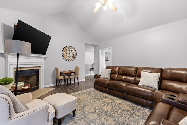 living room with ceiling fan, high vaulted ceiling, dark hardwood / wood-style floors, and a fireplace