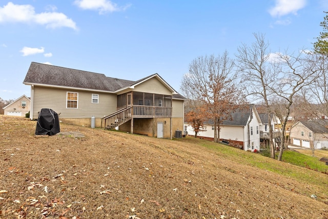 back of property featuring a yard, a sunroom, and central air condition unit