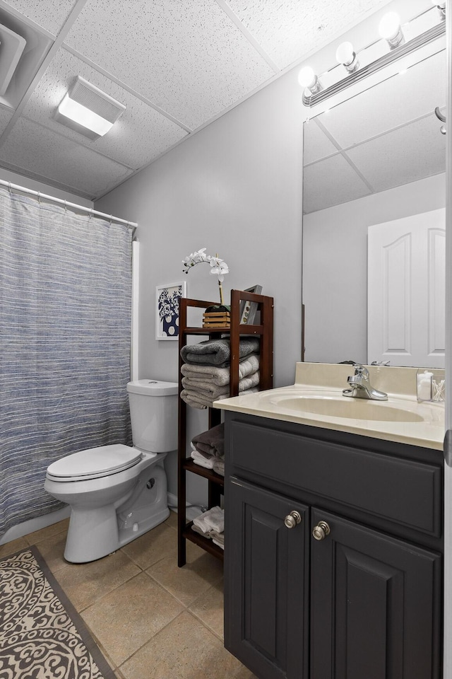 bathroom featuring vanity, a shower with curtain, a paneled ceiling, and toilet