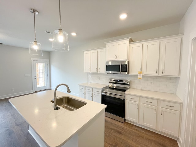 kitchen featuring white cabinets, an island with sink, stainless steel appliances, and sink