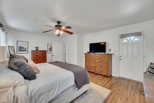 bedroom with a ceiling fan and light wood-style floors