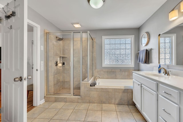 full bathroom with a stall shower, tile patterned flooring, vanity, and a bath