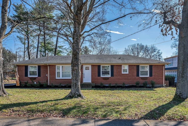 ranch-style home featuring brick siding and a front yard