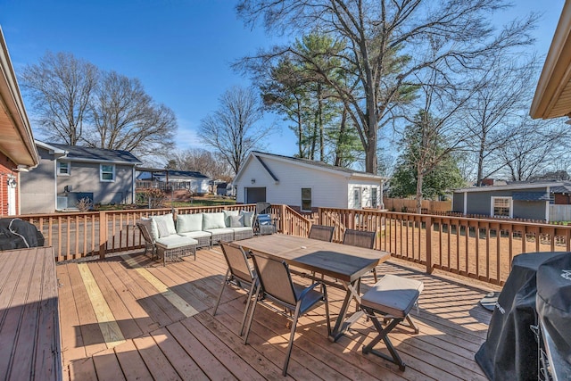 wooden terrace with area for grilling, a residential view, an outbuilding, outdoor dining area, and an outdoor living space