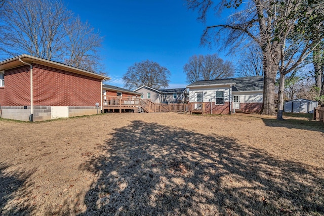 view of yard featuring a wooden deck