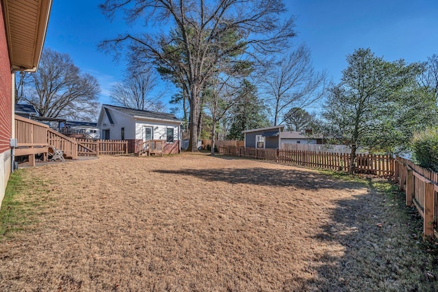 view of yard with an outdoor structure and a fenced backyard