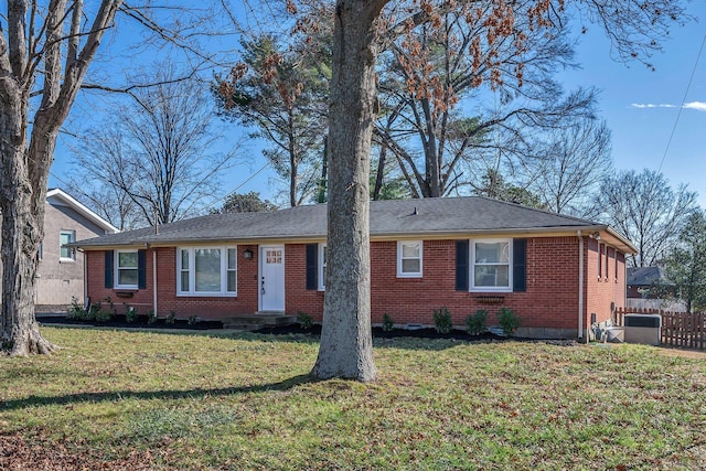 single story home featuring central AC, brick siding, a front lawn, and fence