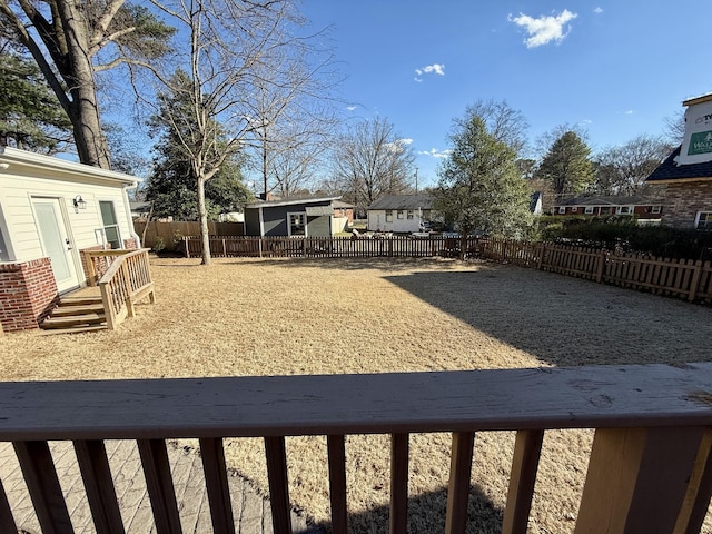 view of yard with a deck and a fenced backyard