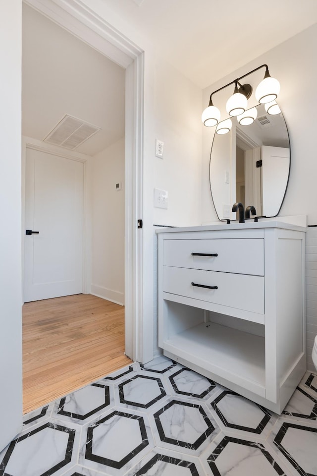 bathroom with hardwood / wood-style floors and vanity