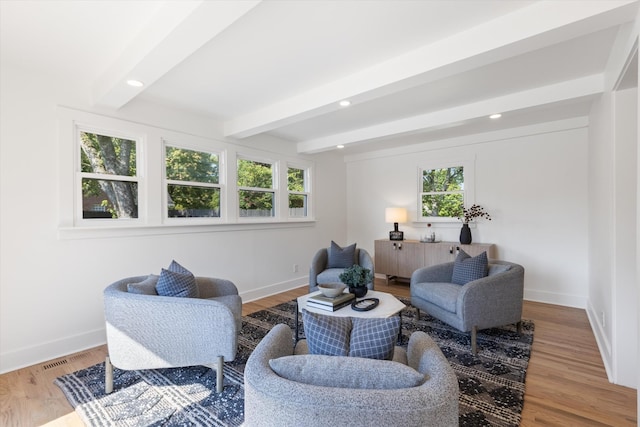 living room with beam ceiling and hardwood / wood-style flooring