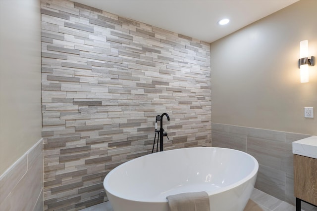 bathroom with a washtub and tile walls