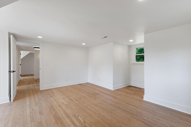 empty room with light hardwood / wood-style flooring