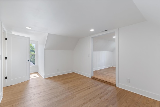 bonus room featuring vaulted ceiling and light hardwood / wood-style flooring