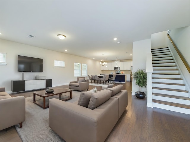 living room with wood-type flooring and a notable chandelier