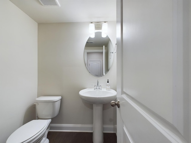 bathroom featuring hardwood / wood-style flooring, sink, and toilet