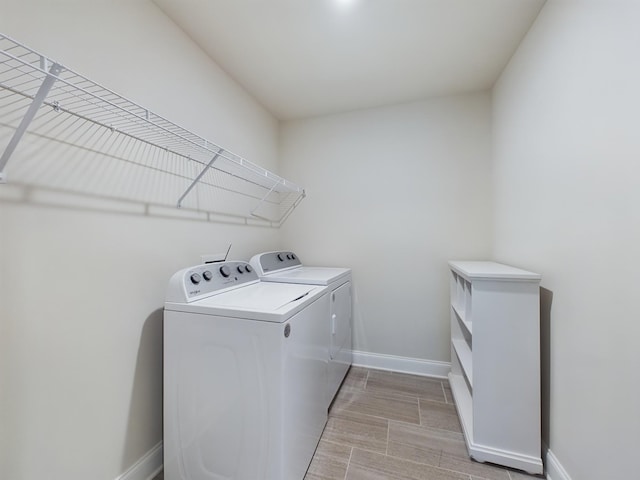 clothes washing area with washer and dryer