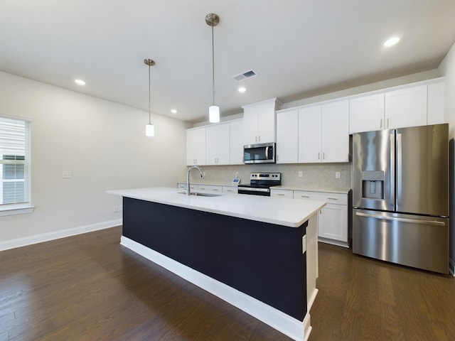 kitchen featuring stainless steel appliances, sink, a center island with sink, white cabinetry, and hanging light fixtures