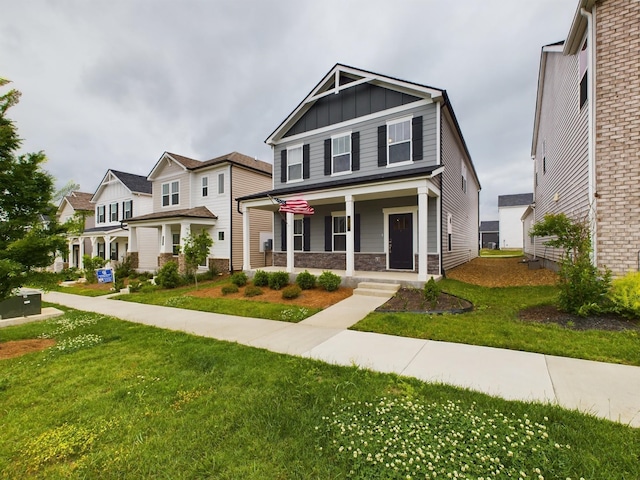 craftsman-style house featuring covered porch and a front yard