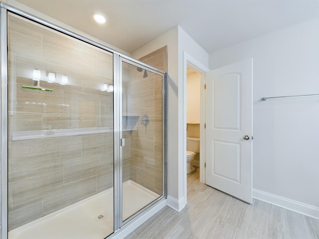 bathroom featuring walk in shower and toilet