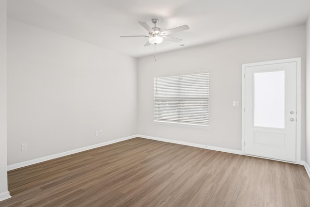 unfurnished room featuring hardwood / wood-style floors and ceiling fan