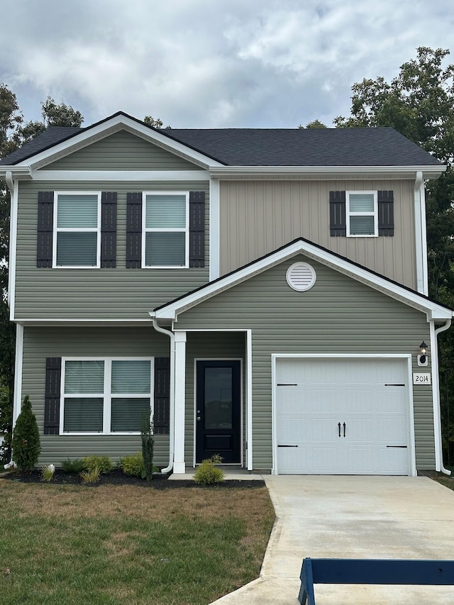 view of front facade with a garage and a front lawn