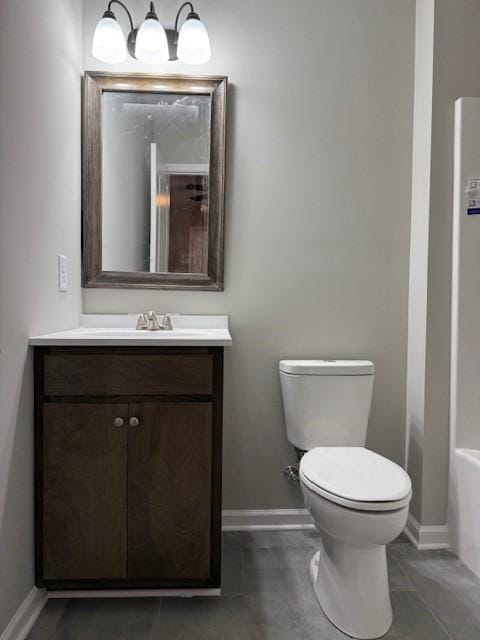 bathroom with tile patterned flooring, vanity, and toilet